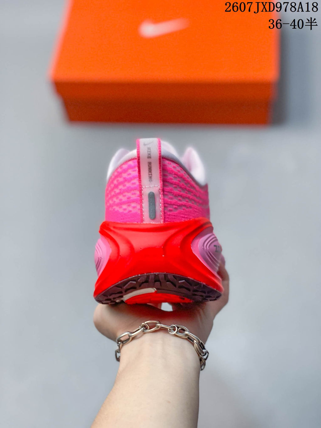 Nike Vomero Plus Running Sneakers in Pink Red - product image from the listing.