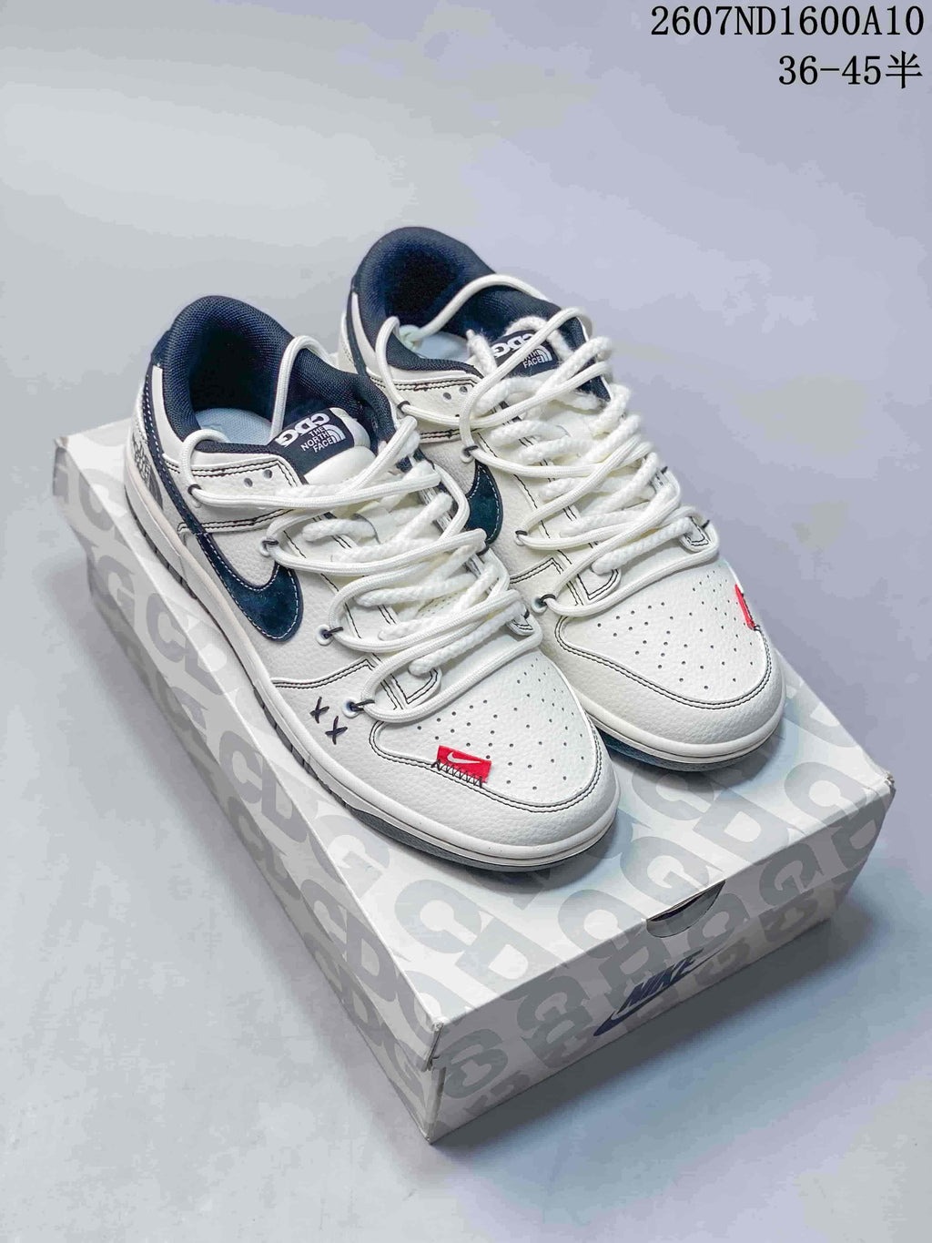 Nike SB Dunk Low Sneakers in White Navy 2607ND1600A10 - product image from the listing.