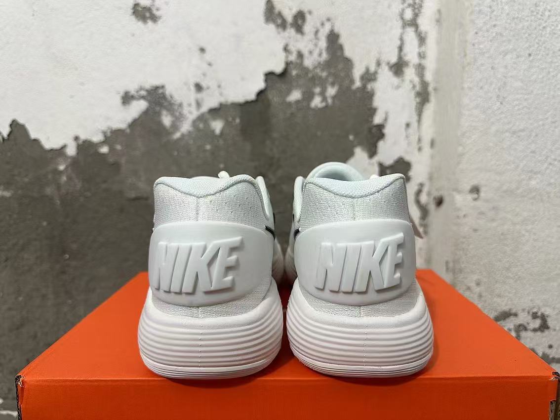 Nike White Basketball Footwear with Black Swoosh - product image from the listing.