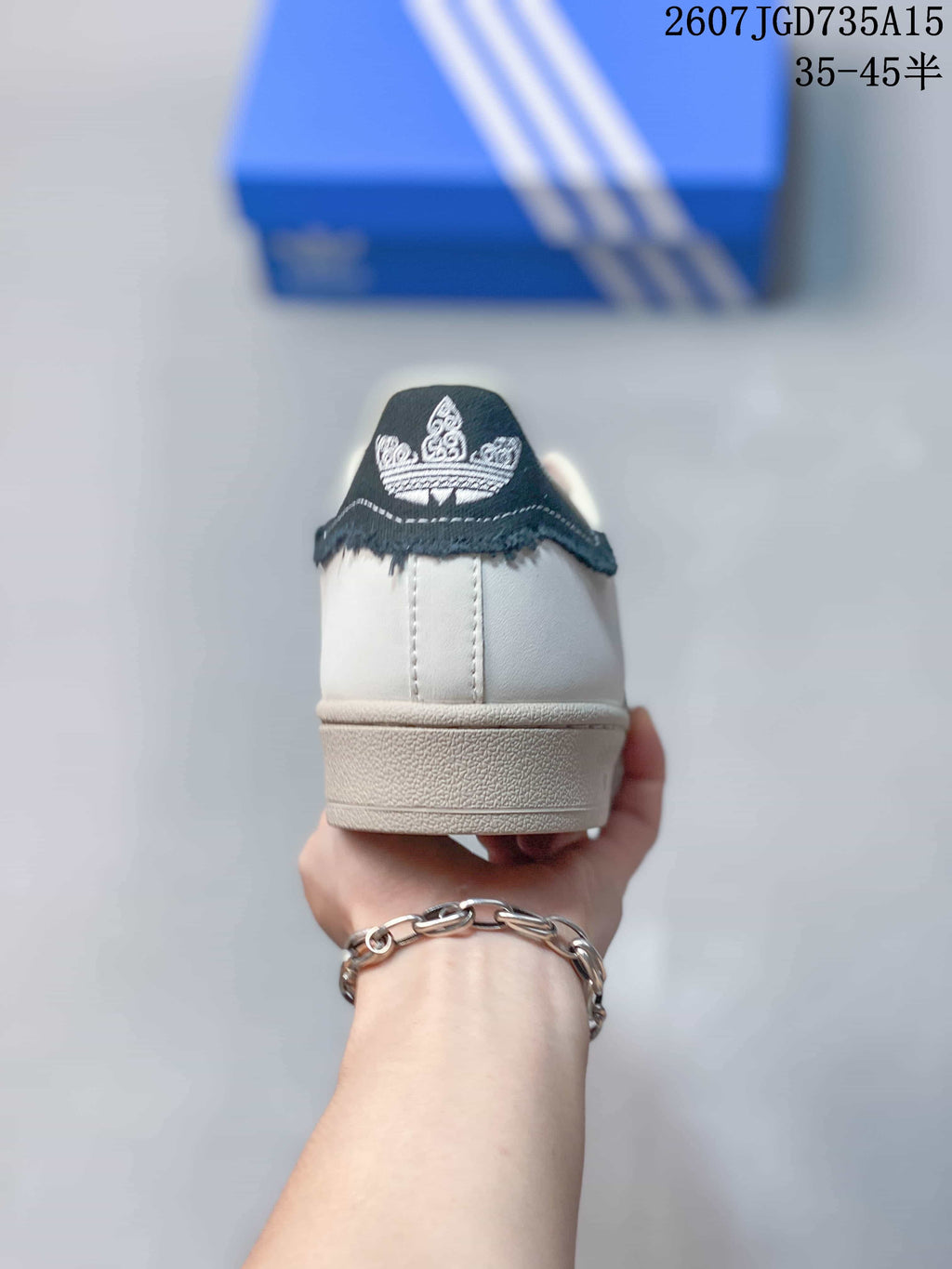 adidas Superstar Shell-Toe Sneakers in White and Black - product image from the listing.