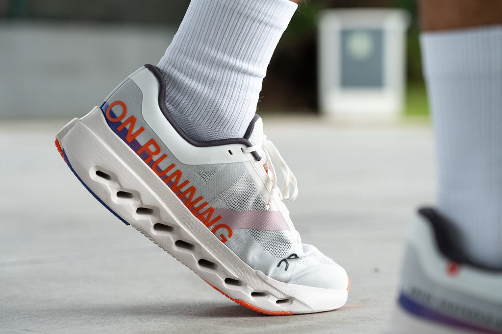 On Cloudsurfer Next Running Shoes in White Orange - product image from the listing.