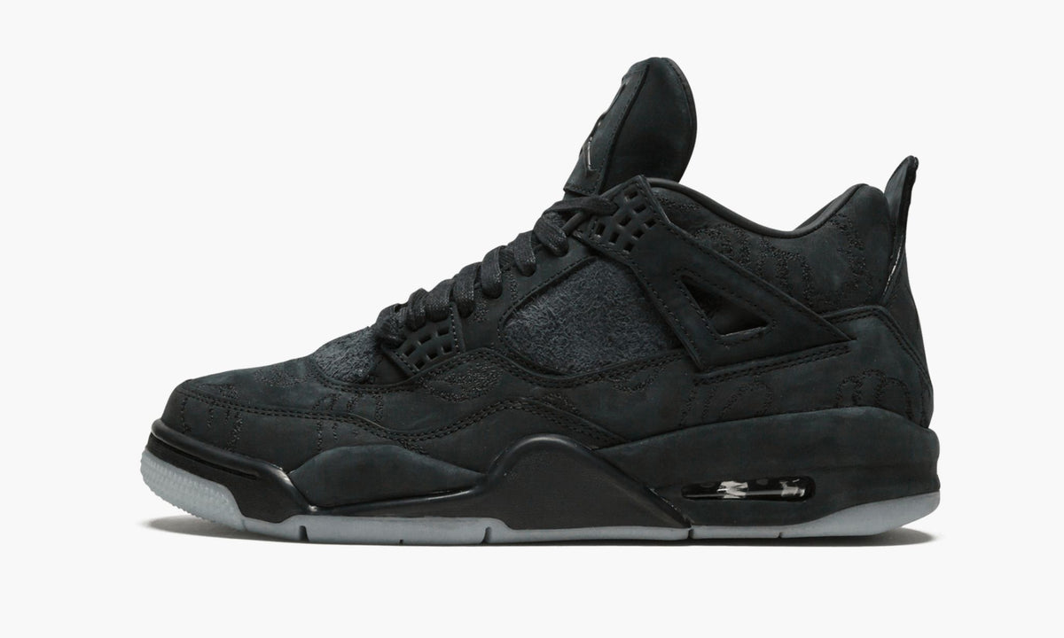 Black Sneakers - Air Jordan 4 Retro Kaws - product image from the listing.