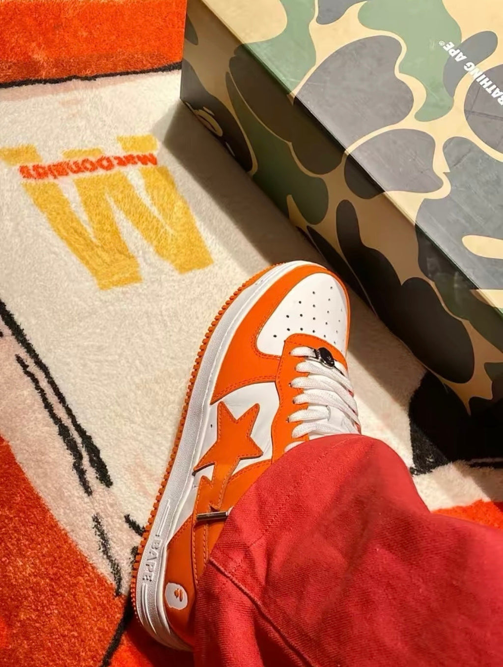 A Bathing Ape BAPE STA Low Sneakers in White Orange - product image from the listing.