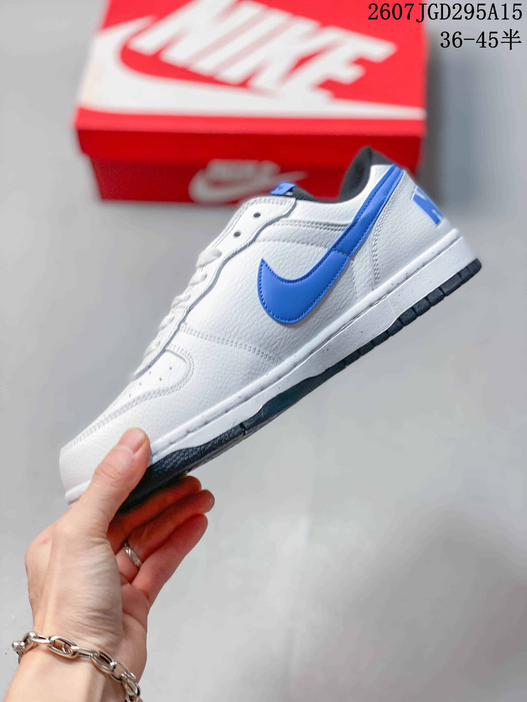 Nike SB Dunk Low Pro Sneakers in White Blue 2607TGD295A15 - product image from the listing.