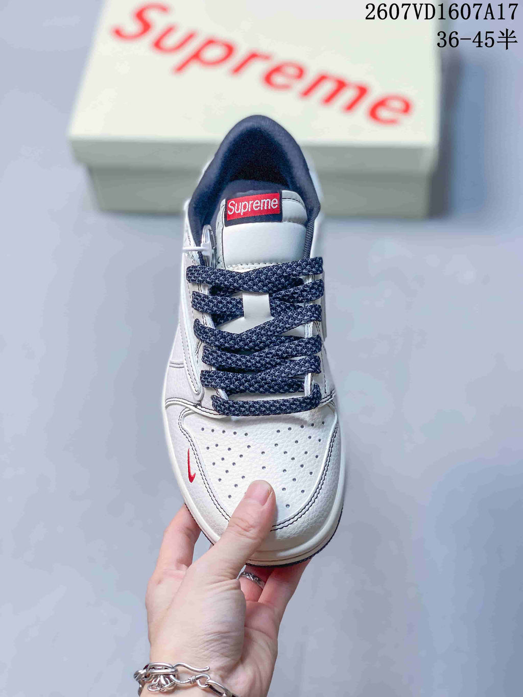 Jordan 1 Low Sneakers in White and Navy - product image from the listing.
