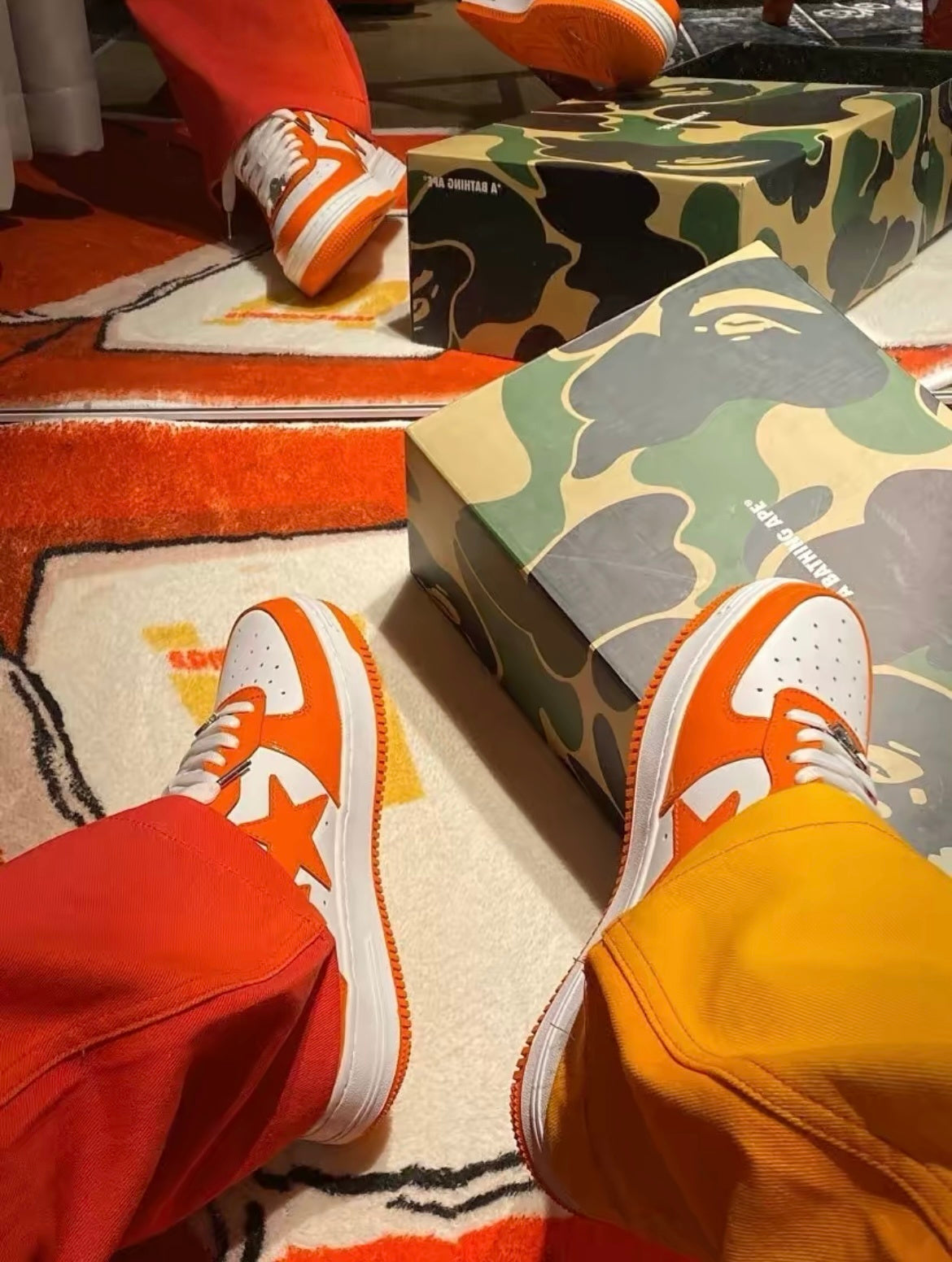 A Bathing Ape BAPE STA Low Sneakers in White Orange - product image from the listing.